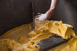 Bungay Butter, raw milk cultured butter hand churned at Fen Farm Dairy in Suffolk. A handful of salt is thrown into freshly churned, golden butter.