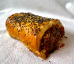 A flaky, buttery, bronzed pastry is sprinkled with poppy seeds and wrapped around a filling of mushroom, leek, pinhead oats and seasoning, shaped like a sausage roll